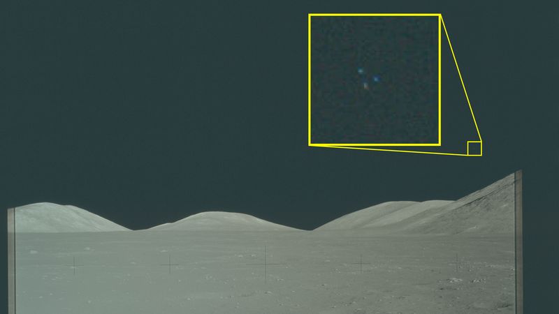 hills on the moon and in a very zoomed in inset three colorful dots.