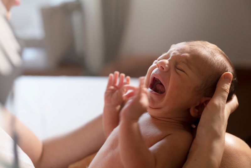 close-up of a newborn baby crying