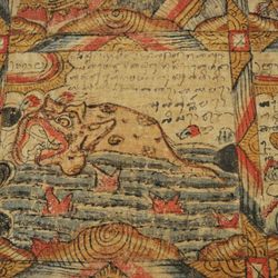 Close-up of a Balinese astrological calendar, which shows a grid filled with artwork, including a rendition of a fish.