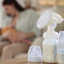 Mother and baby with expressed breast milk