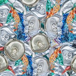 top-down view of multiple crushed beverage cans placed close together