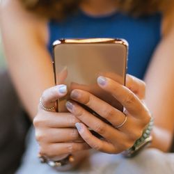 Close up of a woman's hands holding a cell phone 