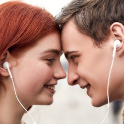 Close up of happy couple of teenagers listening to music using the same pair of earphones, looking at each other with love (left); Smiling active senior couple having fun together in the park (right)