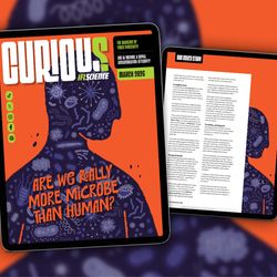 The cover of IFLScience's CURIOUS magazine as shown on an iPad. The background is orange with a purple-colored silhouette of a person covered in microbes. The cover line in orange says “are we really more microbe than human?”
