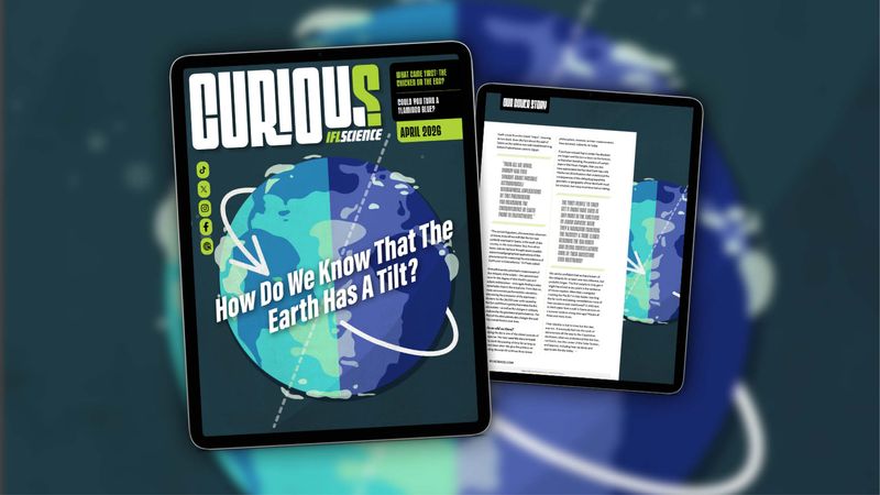 The cover of IFLScience's CURIOUS magazine as shown on an iPad. The background is dark blue-black with an illustration of the Earth on a tilt. The cover line in white says “how do we know that the Earth has a tilt?”