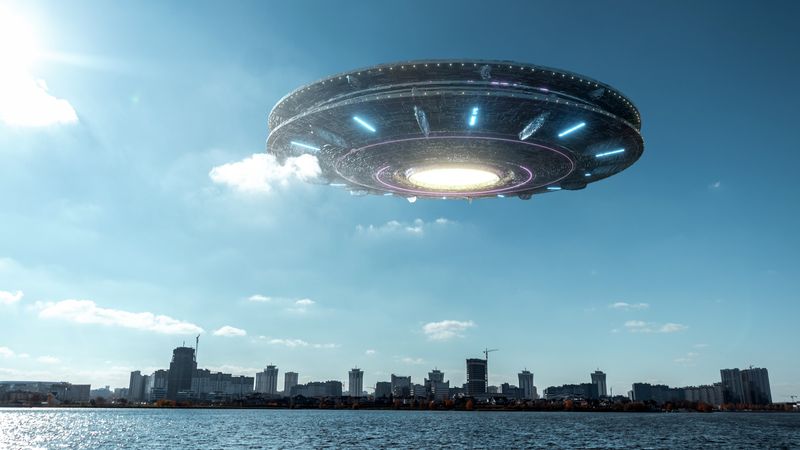 a 3d rendered alien vessel hovering over a city