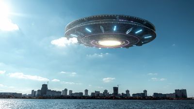 a 3d rendered alien vessel hovering over a city