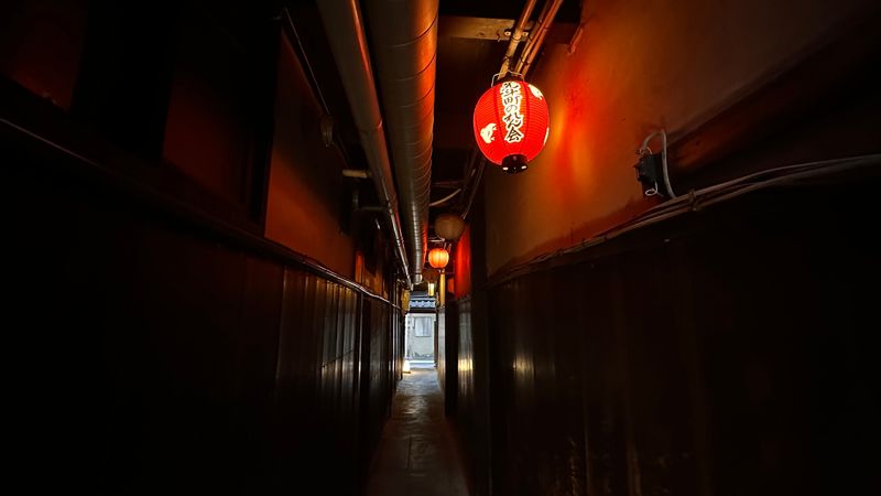 A lantern lights up a lonely street in Kyoto, Japan.