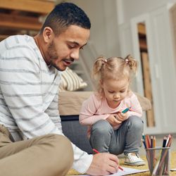 man drawing with young girl