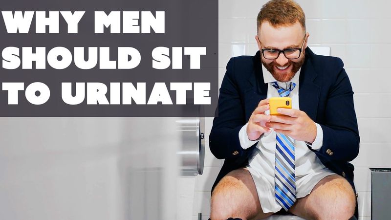 a man sitting to pee