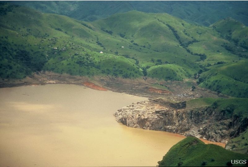 view of a lake surrounded by green hills 