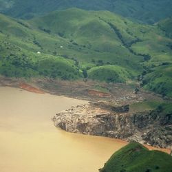 view of a lake surrounded by green hills 