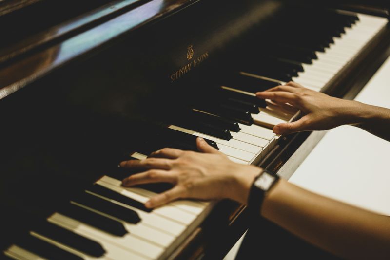hands on a Steinway grand piano
