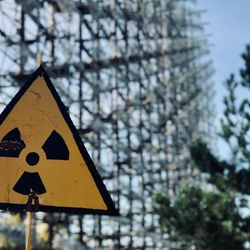 A radiation warning sign sits below the Duga array within the Chernobyl Exclusion Zone.