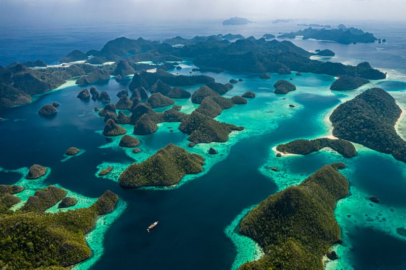 aerial drone image of a remote, hilly group of tropical islands