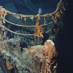 The RMS Titanic rests at the bottom of the Atlantic Ocean at a depth of approximately 12,500 feet (3,800 meters).