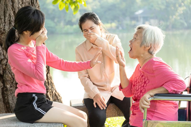 Smelly Grandma and two young women covering their noses and mouths.