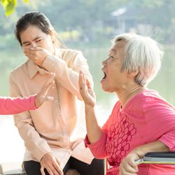 Smelly Grandma and two young women covering their noses and mouths.
