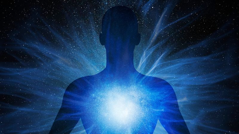 Human sillhouteed with an exploding star inside, stretching into a space background