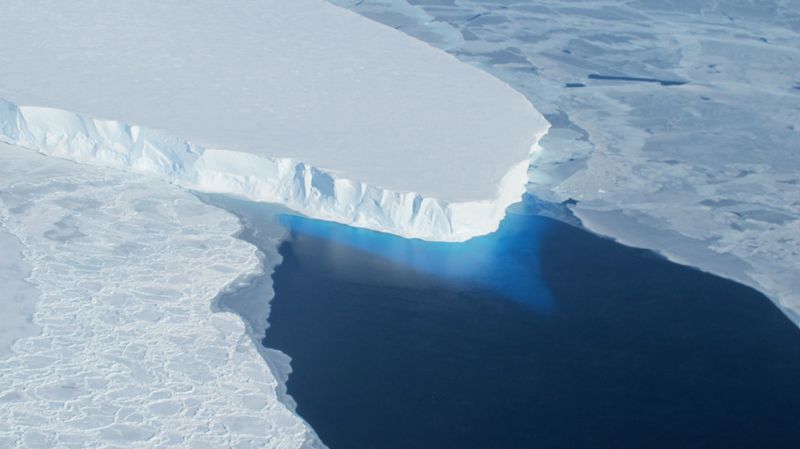 Thwaites Glacier in West Antarctica, a large body of ice surrounded by blue water.