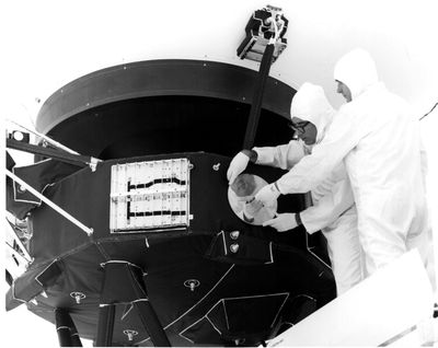 Engineers secure the cover over the Voyager 1 Golden Record in this archival image from 1977.