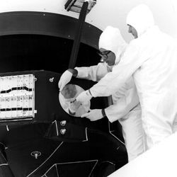 Engineers secure the cover over the Voyager 1 Golden Record in this archival image from 1977.