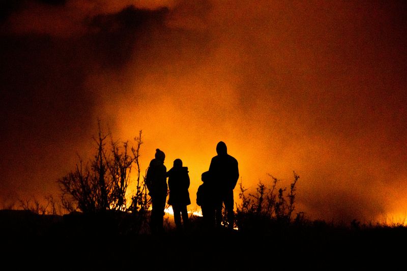 Family watching a wildfire in the distance in the summer of 2020.