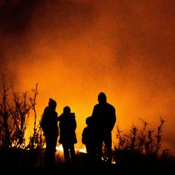 Family watching a wildfire in the distance in the summer of 2020.
