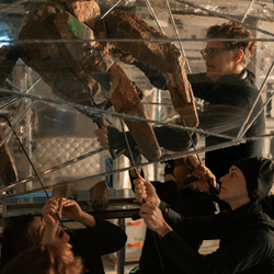 puppet designer james ortiz operates rocky the eridian puppet with aid of "the rocketeets"