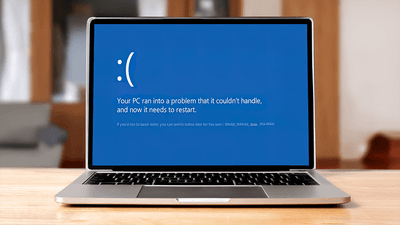 An error message on a laptop informing the user they need to restart their device.