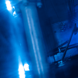 Blue glowing water caused by Cherenkov radiation in a nuclear reactor core.