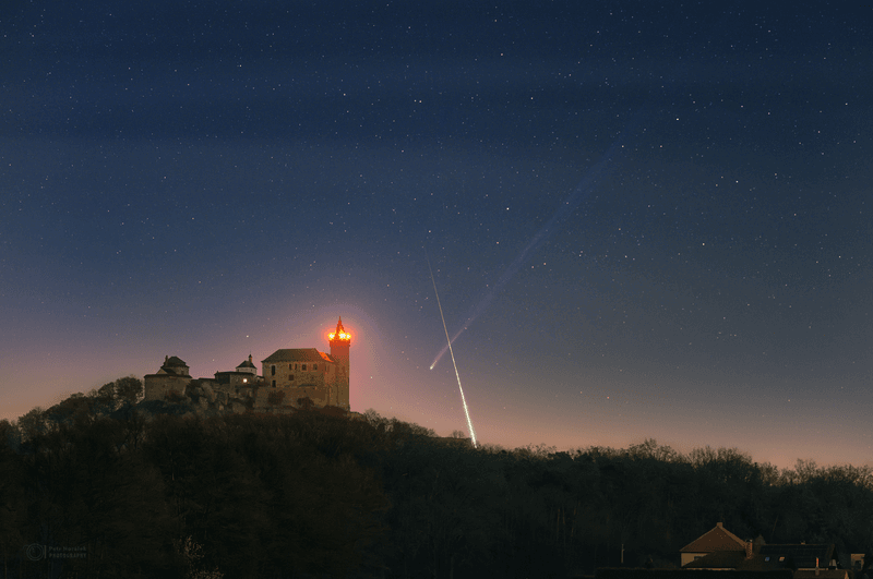 Comet C/2025 R3 streaks above Kunetice Castle as a fireball blazes through the same frame.