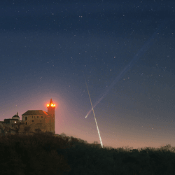 Comet C/2025 R3 streaks above Kunetice Castle as a fireball blazes through the same frame.