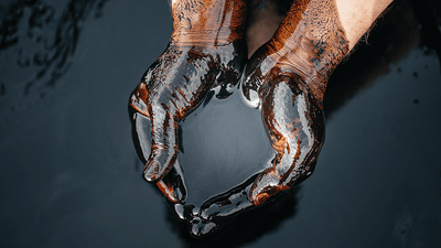 Crude oil being held in hands.