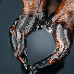 Crude oil being held in hands.