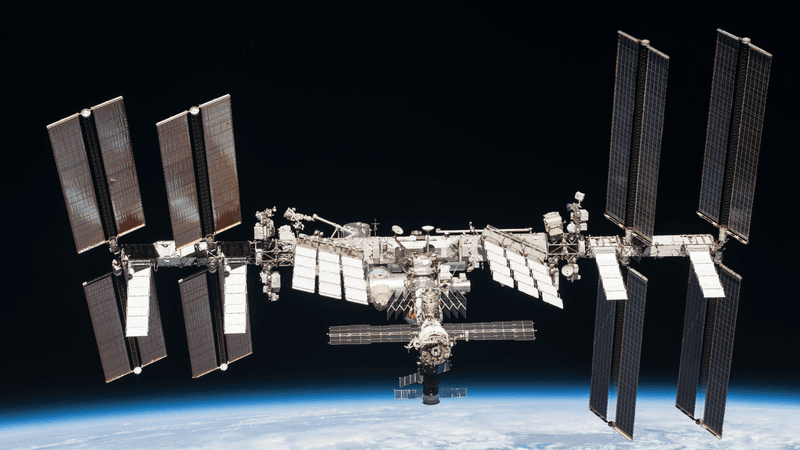 A photo of the ISS and beyond the limb of the Earth.