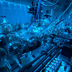a metallic cylinders connected to gauges and cables where the quantum mechanics magic happens.
