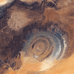 The Richat structure, viewed from above. A circular feature peaks out through the Sahara desert.
