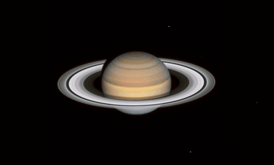 staurn is seen with its rings widely visible and shinging in white