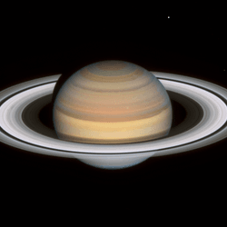 staurn is seen with its rings widely visible and shinging in white