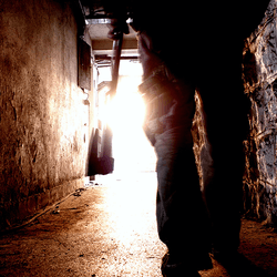 A man walking through a corridor with an axe.