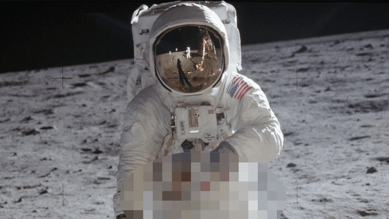 Buzz Aldrin in astronaut suit on the Moon. Neil Armstrong can be seen in the reflection on his visor.